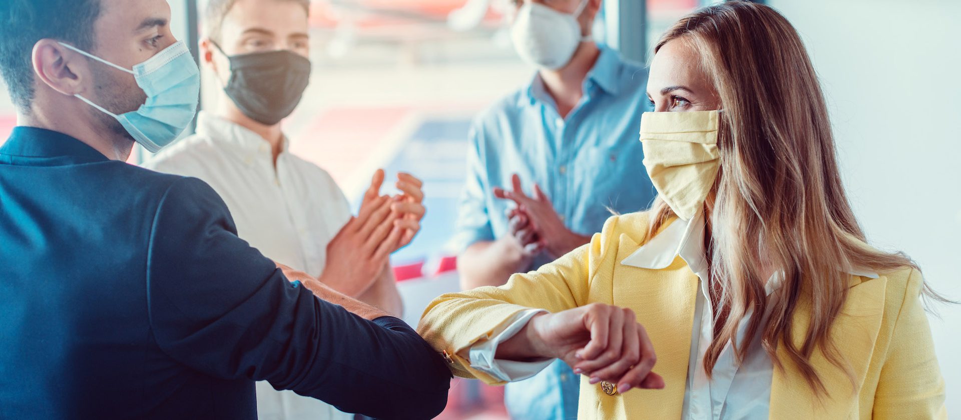 Colleagues greeting with an elbow bump